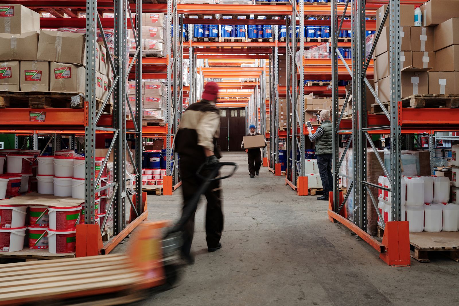 Warehouse staff organizing stored items on shelves