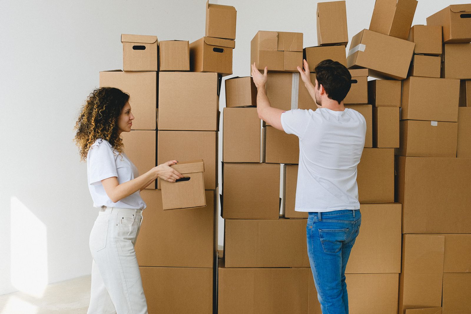 Family carrying boxes into their new home