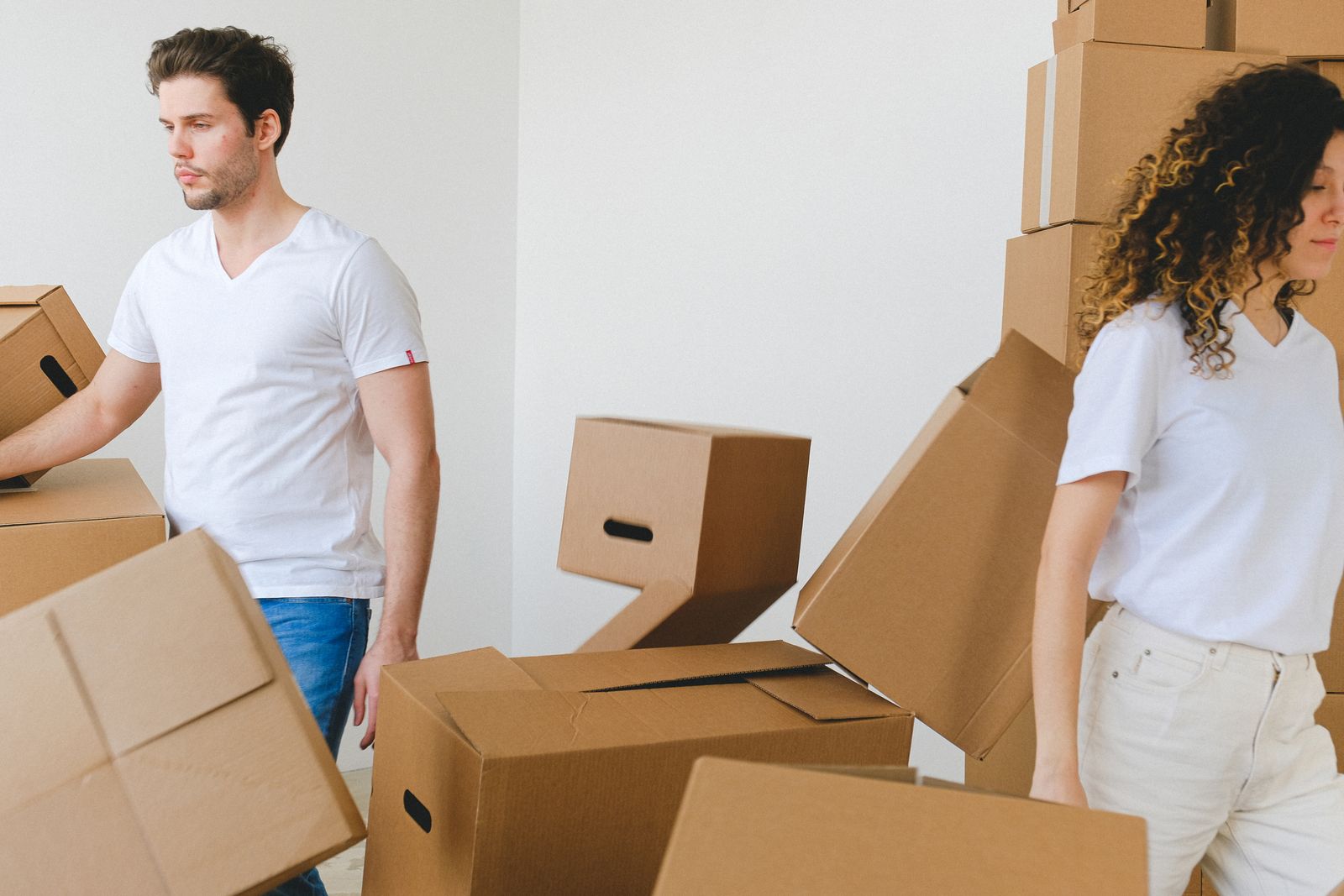 Family carrying boxes into their new home