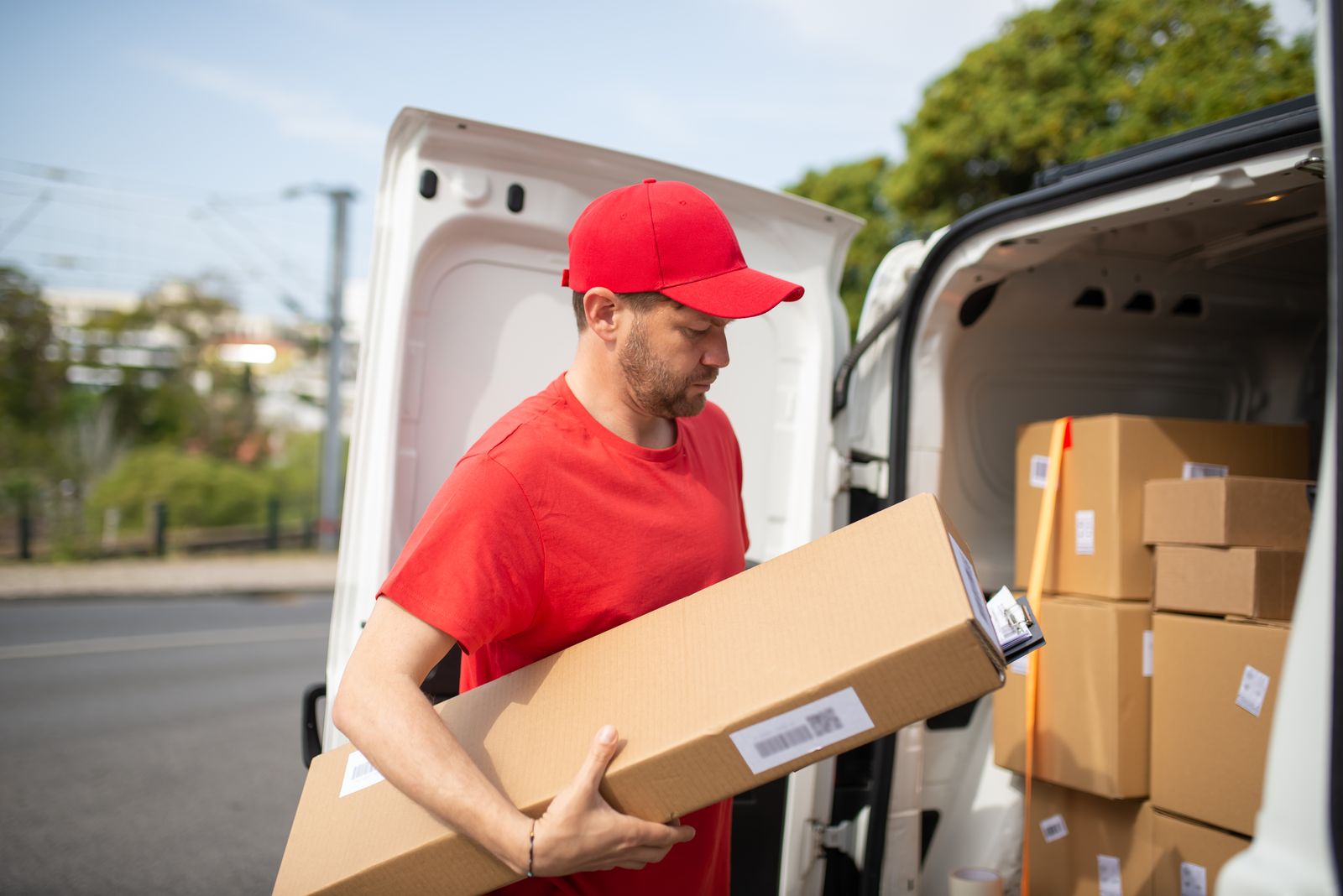 Nomad crew member loading boxes into a van